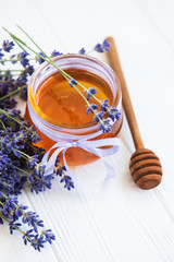 Jar with honey and fresh lavender flowers