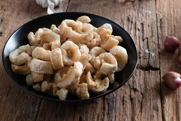 Pork rinds also known as chicharon or chicharrones , kab moo