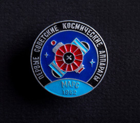 Earth satellite space badge USSR icon vintage on black  background macro.