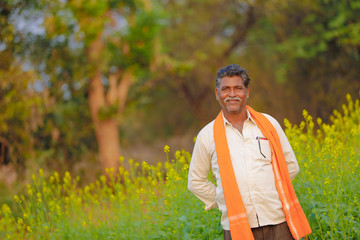 Indian farmer at black musterd field