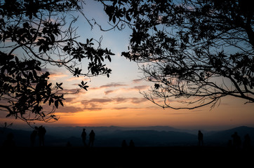 silhouette of people at the top of hill