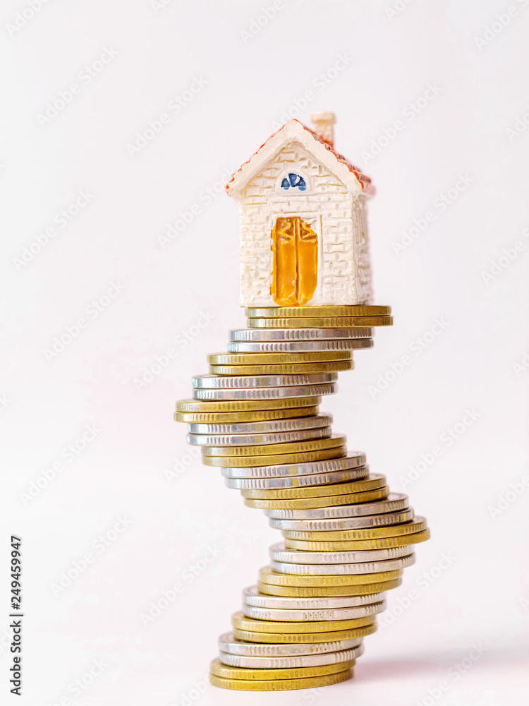 Wall mural real estate or property investment concept. house model on coin stack