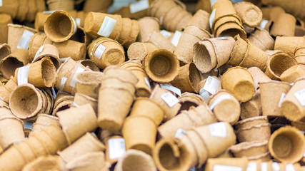Many peat pots on the shelf in the store.