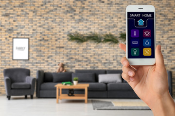 Modern living room interior with comfortable sofa and tropical leaves on brick wall