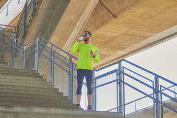 Sportsman working out / jogging on a big city urban bridge.