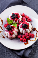 Curd-chocolate dessert without sugar with fresh raspberries, blackberry and mint. Healthy eating. The concept of a healthy diet.