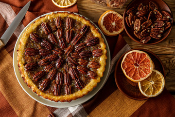 Plate with tasty pecan pie on table