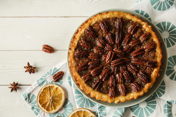 Plate with tasty pecan pie on white table