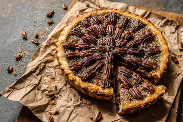 Tasty pecan pie on grey background