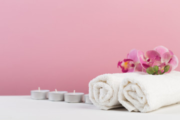 Fototapeta na wymiar Spa still life with aromatic candles, flower and towel. - Image.