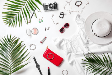 Composition with stylish female clothes, accessories and photo camera on white background