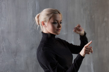 Young woman, business style. Points her finger at the invisible interface