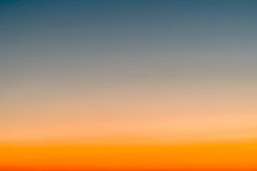 Poster Sky gradient from blue to orange sunset © EKKAPON