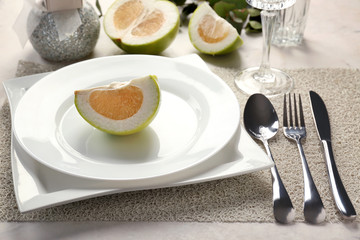Beautiful table setting with citrus fruit