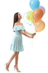 Fototapeta na wymiar Beautiful young woman with balloons on white background