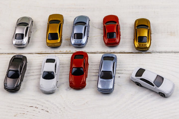Cars toys on white wooden background
