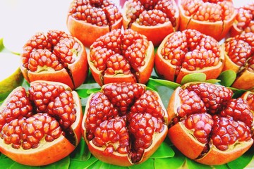 many pomegranate cut in half, pomegranate background close up
