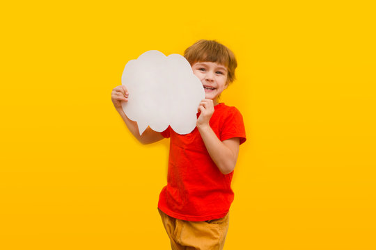 Happy Child Holds Speech Bubble Icon On A Yellow Background.