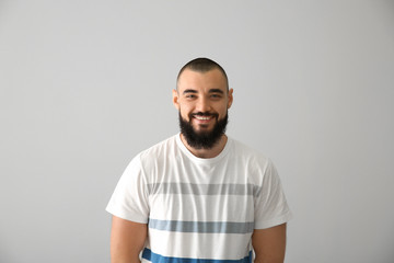 Happy bearded man on light background