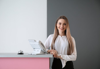 Female receptionist near desk in hotel