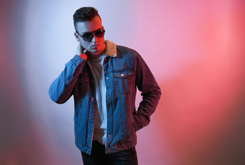 Toned portrait of handsome young man on color background