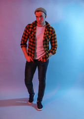 Fototapeta premium Toned portrait of handsome young man on color background