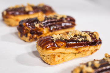 Food, desserts and bakery concept - Traditional French dessert eclairs with chocolate and nuts