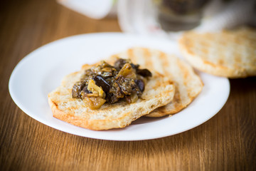 appetizer of cooked eggplant with vegetables on bread