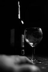 Wine Glass and bottle  in the dark