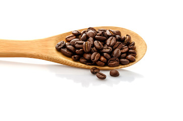 Coffee beans in spoon. Roasted coffee beans. On a white background isolated.