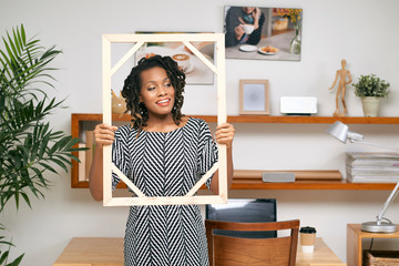 Creative woman posing with frame