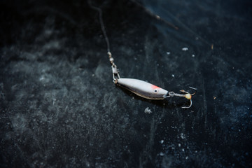 Fishing rod for winter fishing lies on the ice in winter. Winter fishing