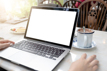 Side view portrait of young businesswoman having business call in office, her workplace, writing down some information. Woman talking on mobile phone, asking questions, looking at pc screen.