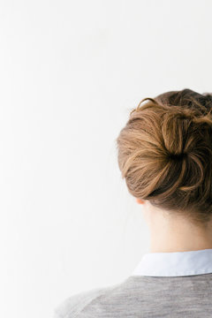 Detail shot of a brunette woman with a chique hair up do.