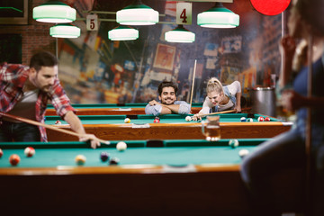 billiard games - friends enjoying playing pool together.