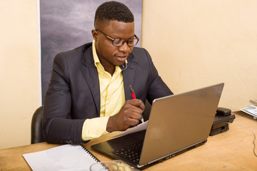 portrait of young man in office, smiling.