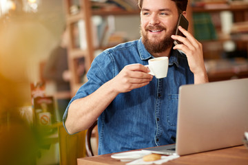 Man in library talking and working