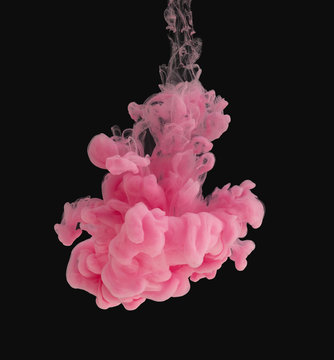 Pink Ink Cloud In Water Isolated On Black