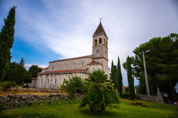 Fototapeta na wymiar old beautiful church on an island in Croatia, Grohote church Croatia with beautiful blue sky background