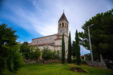 Fototapeta na wymiar old beautiful church on an island in Croatia, Grohote church Croatia with beautiful blue sky background
