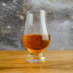 Irish Whiskey Glass on Wood and Slate Background Close Up Square Format