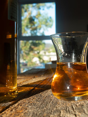 Unique Irish Whiskey Glass And Irish Whiskey Bottle with Sunny Irish Window Behind