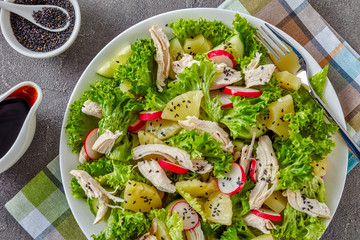 chicken, lettuce salad with ananas and veggies