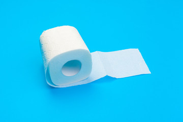Roll of toilet paper on blue color background