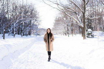 Portrait Young Beautiful asian woman smile happy travel and enjoy with snow winter season