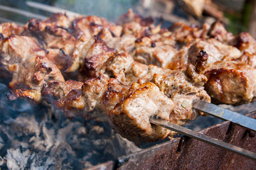 Traditional eastern dish, shish kebab. Roasted meat cooked at barbecue with smoke. .