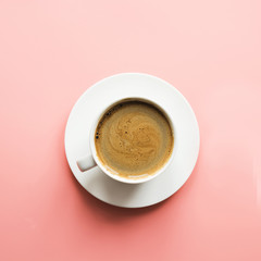 Cup of black coffee on pink background. Isolated. Top view.