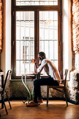 Handsome african man drinking a coffee in establishment