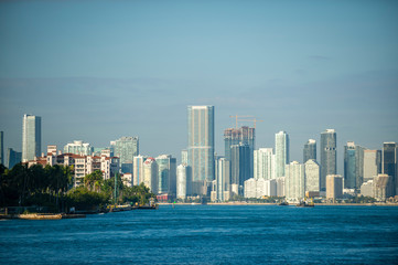 Fototapeta na wymiar Bright tropical scenic view of the city skyline of Miami with waterfront greenery on Biscayne Bay