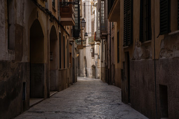 in the streets of palma de Mallorca Spain with great sky in the background, great city photography small little street with typical colour